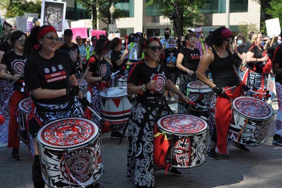 A local chapter of Batala Mundo, an all-women AfroBrazilian percussionist band, leads the protesters to the Supreme Court with galvanizing drum beats.