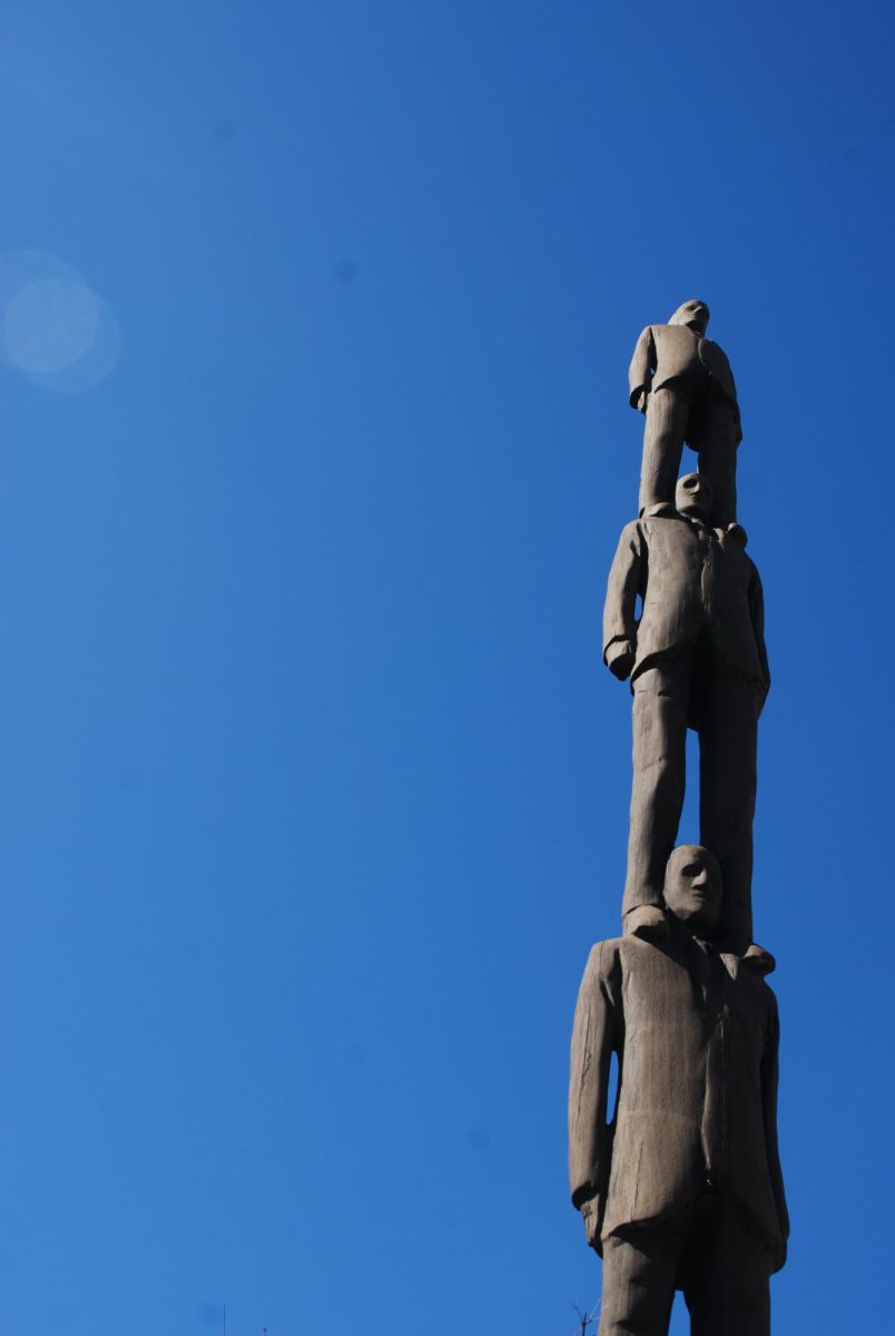 A statue against a clear blue sky in the area behind the Katzen Arts Center.