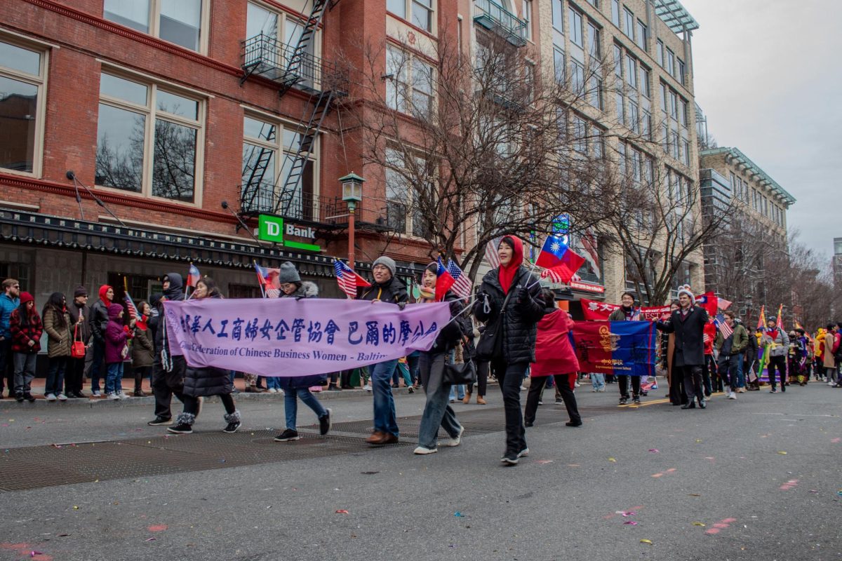 Global Federation of Chinese Businesswomen in Baltimore members holding their banner to start the parade.