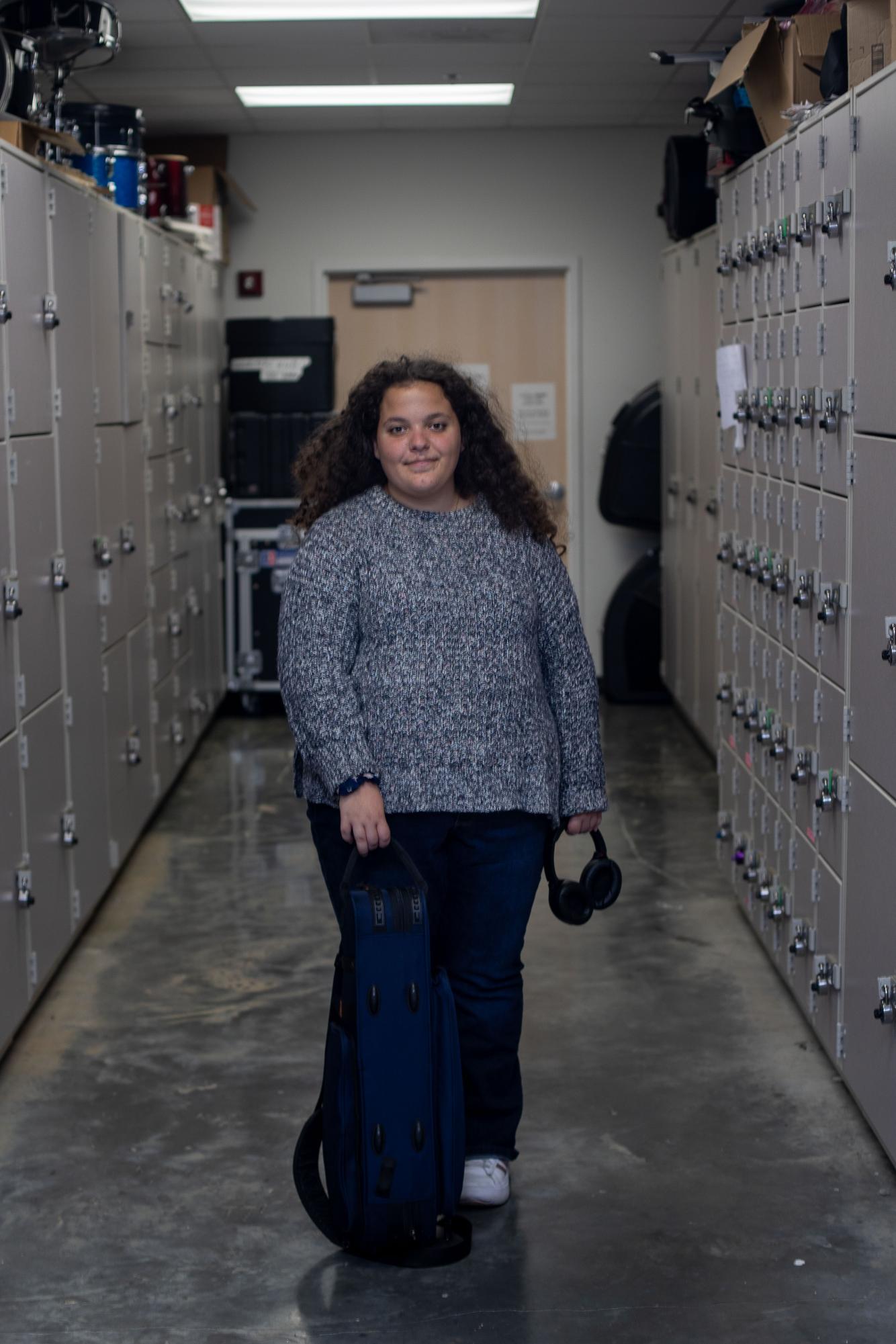Senior Graziella Gulli stands in the Katzen Arts Center with her instrument.